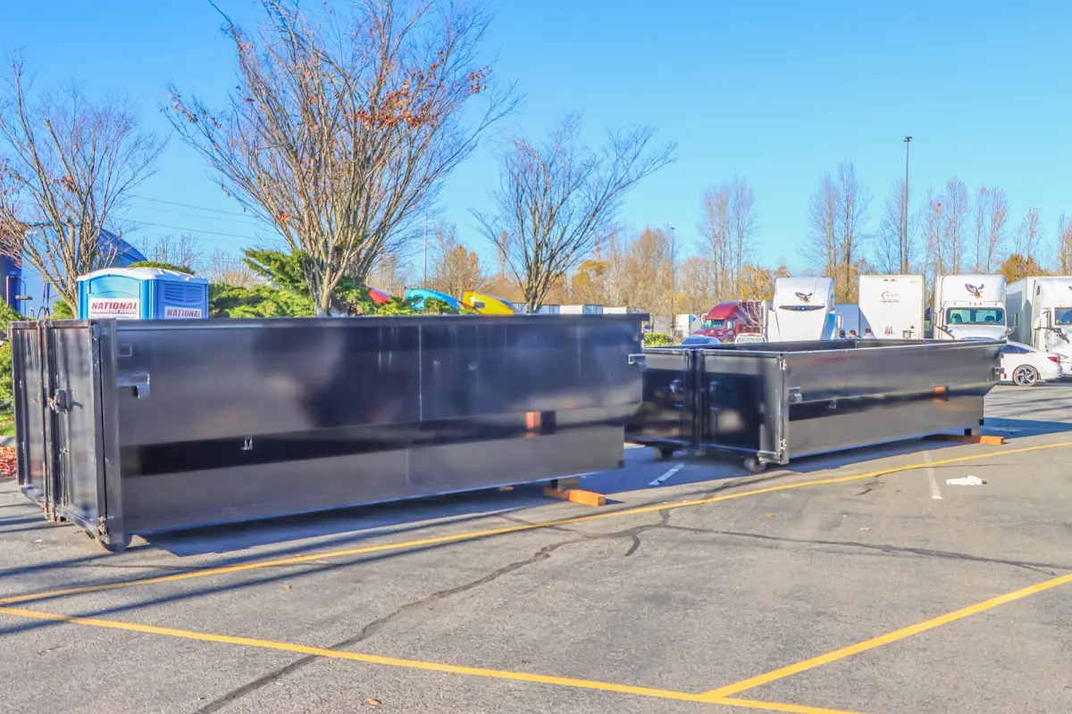 Professional dumpster rental service with roll-off container on residential driveway in Middle Paxton